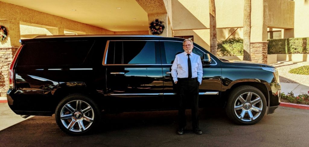 Man Standing in Front of a Limousine Car