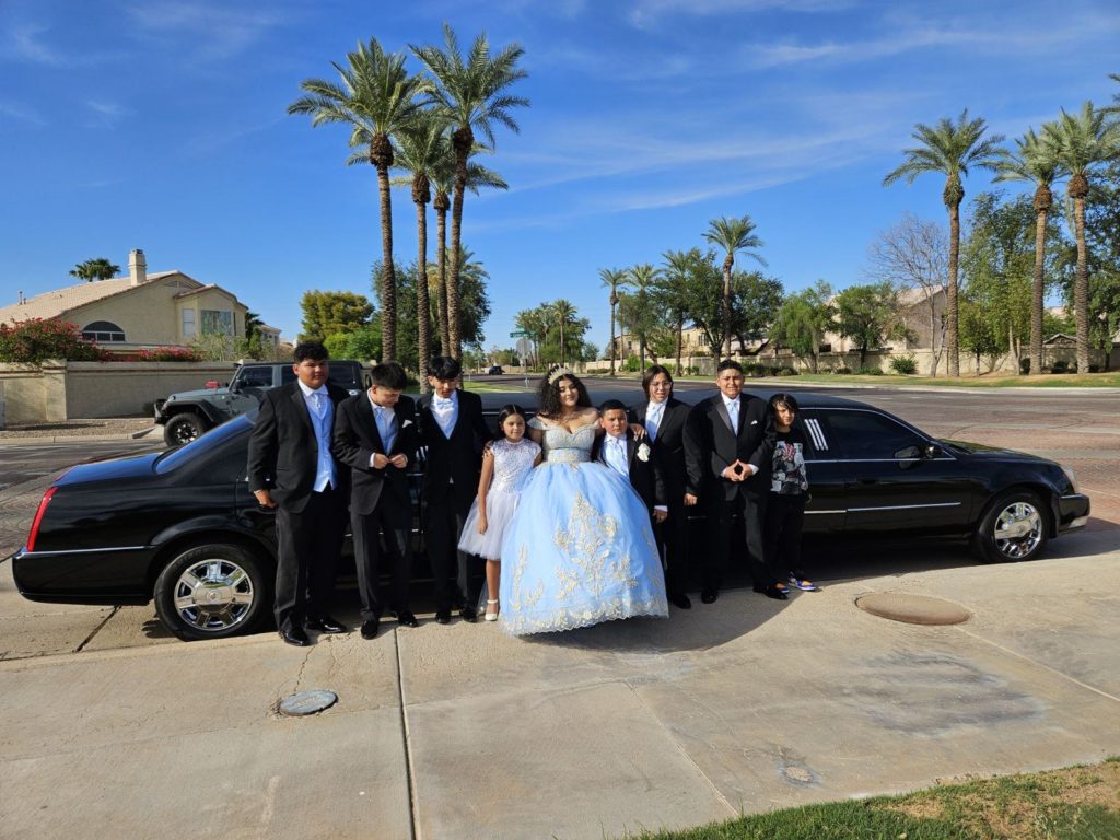 Family Standing in Front of a Limousine Car
